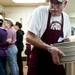 Third-year volunteer Tom Zeimet grabs more plates at St. Frances Church on Friday, March 8. Daniel Brenner I AnnArbor.com